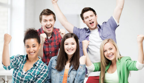 Happy diverse students cheering and celebrating