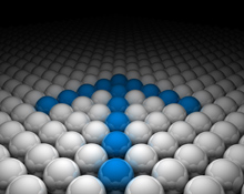Blue spheres forming upward arrow among white spheres