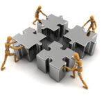 Figures assembling metallic puzzle pieces